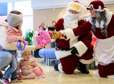 St. Paul Cops and Kids bring Santa, Mrs. Claus (and elves) to Children’s MN