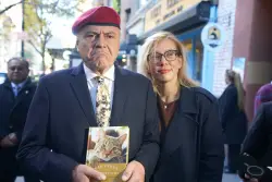 NYC mayoral hopeful Curtis Sliwa shows up to election poll site in cat tie and a book for feline lovers
